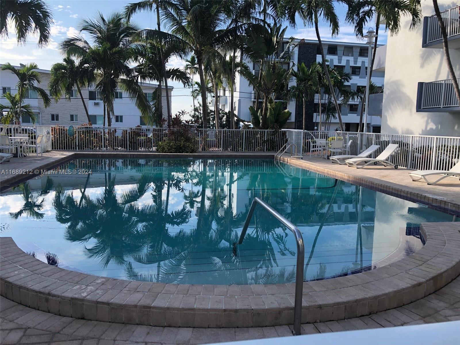 a view of a swimming pool with a table and chairs