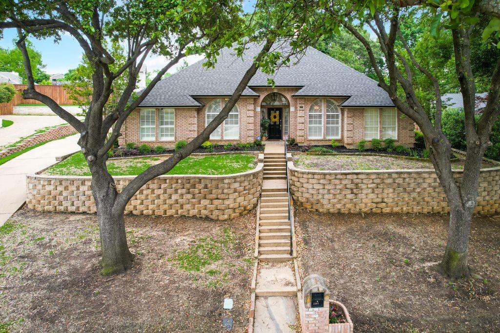 a front view of a house with garden