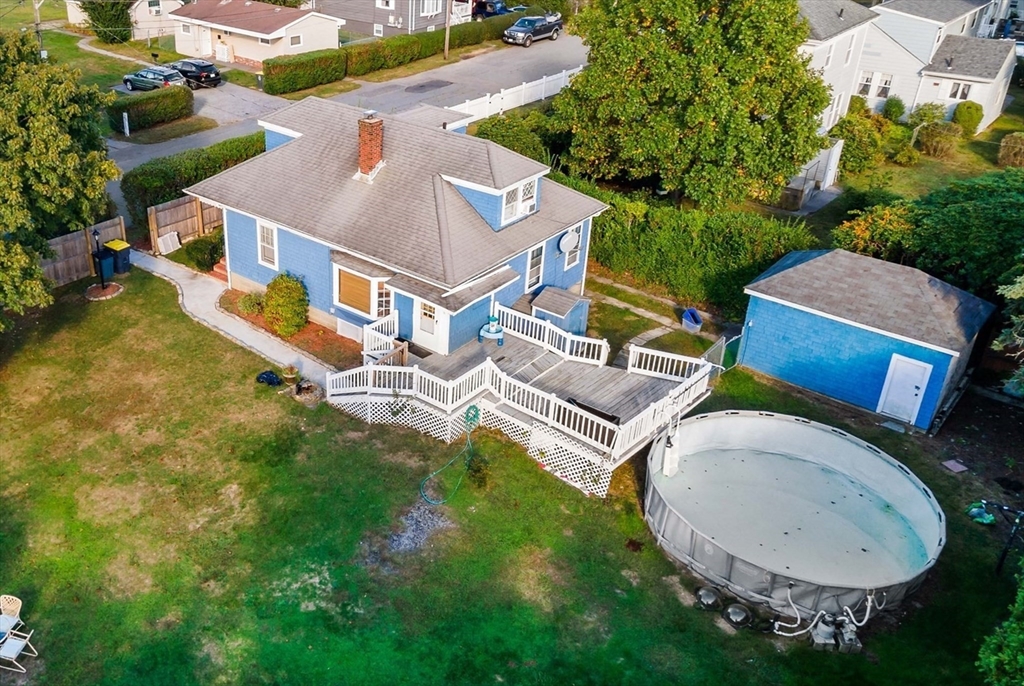 an aerial view of a house with garden space and street view