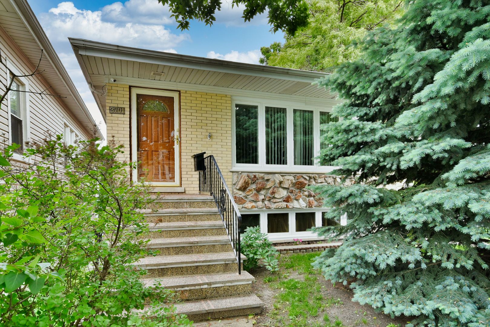 a front view of a house with a garden