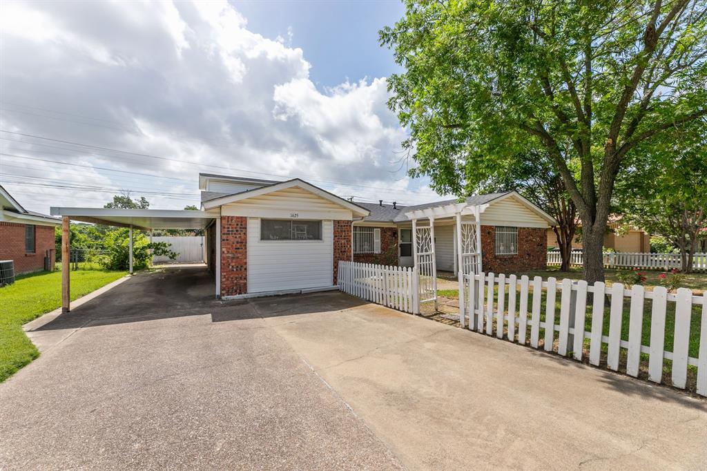 a view of a house with wooden fence