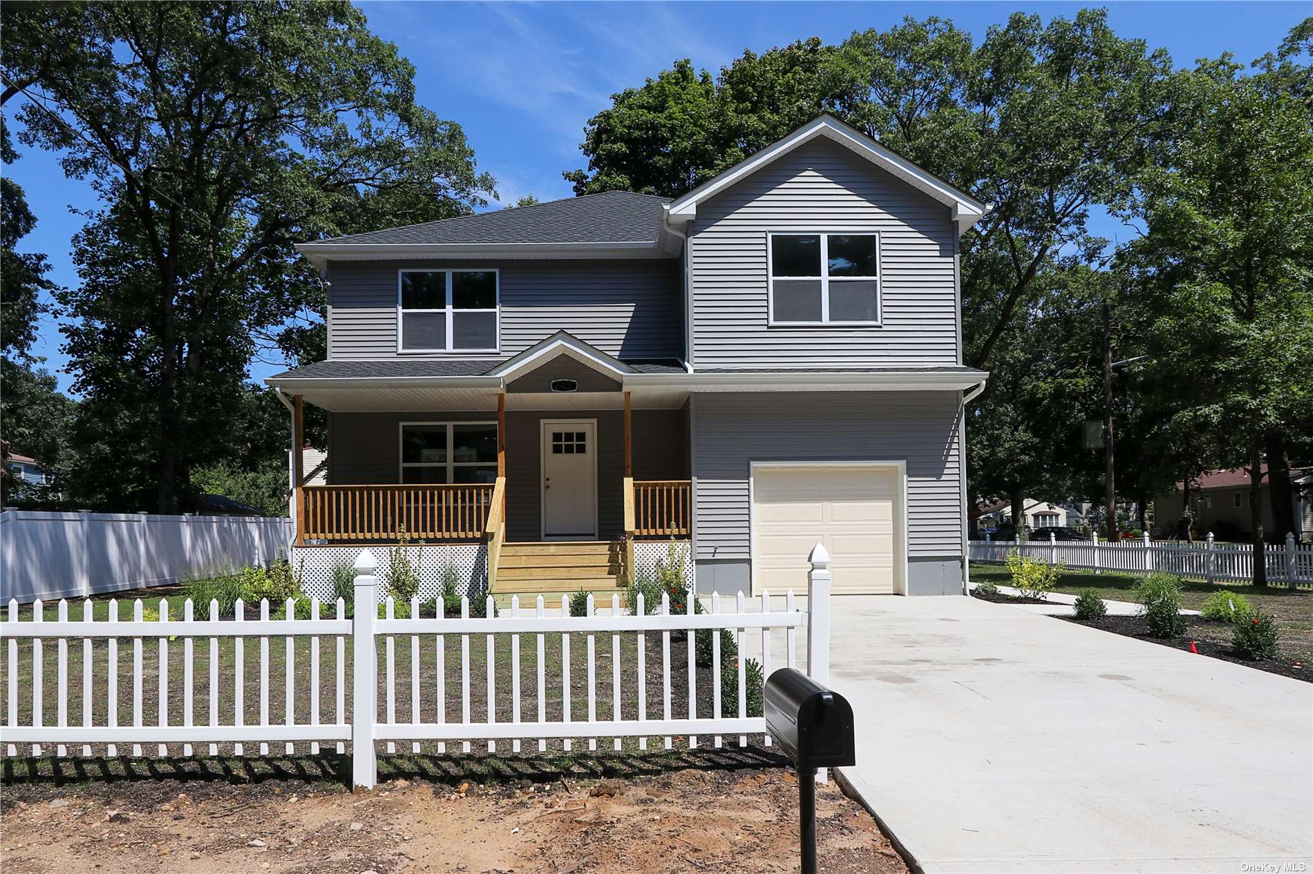 a front view of house with yard and trees