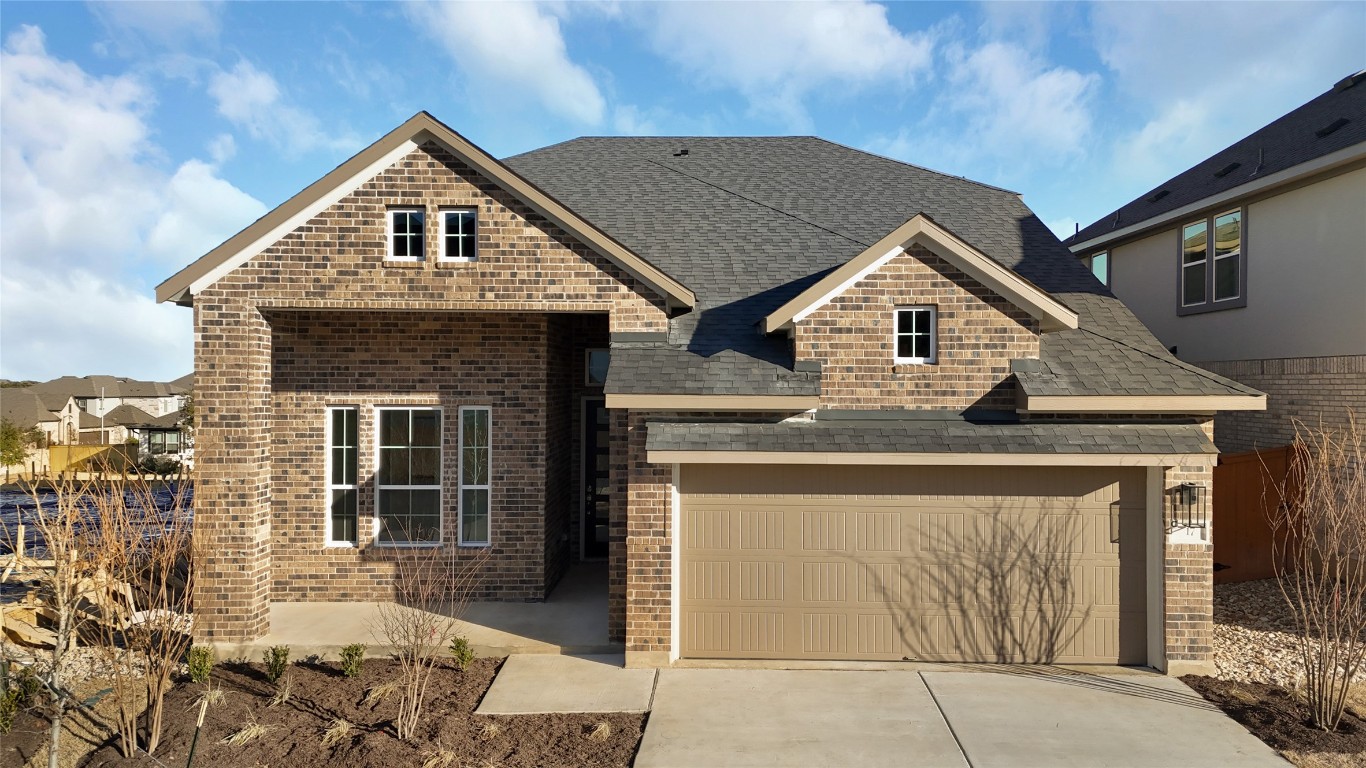 a front view of a house with a garden