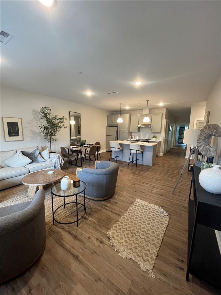 a living room with furniture kitchen view and a table