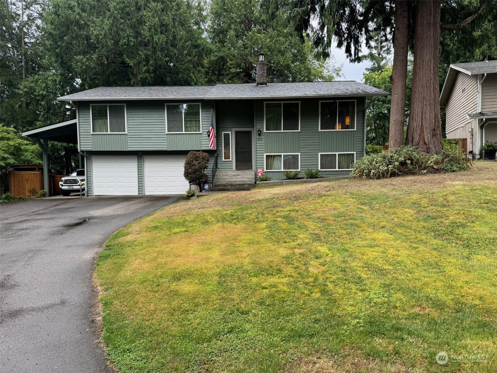 a front view of a house with a garden