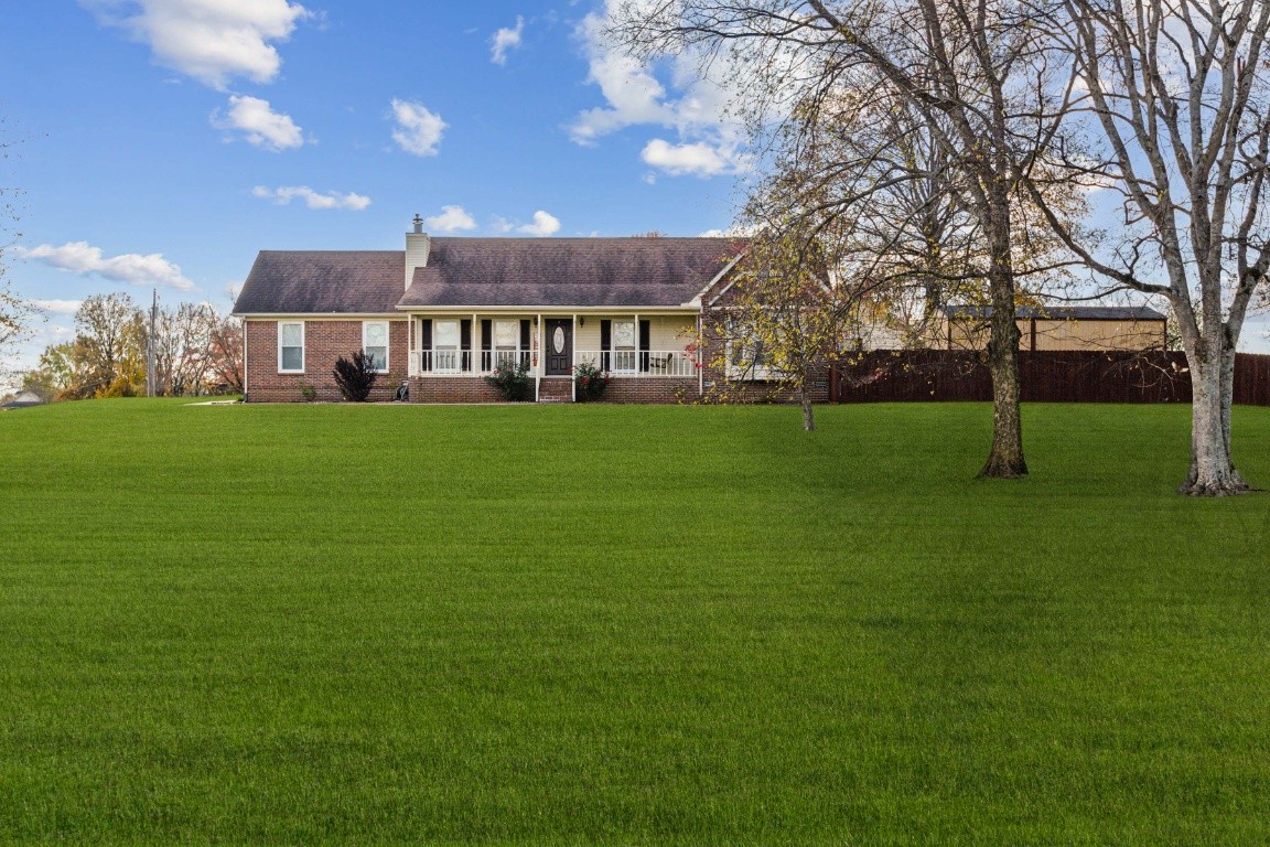 a view of a big house with a big yard