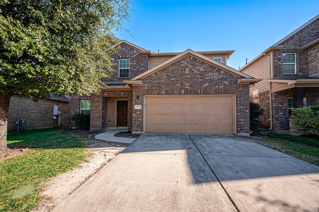 a front view of a house with a yard and a garage