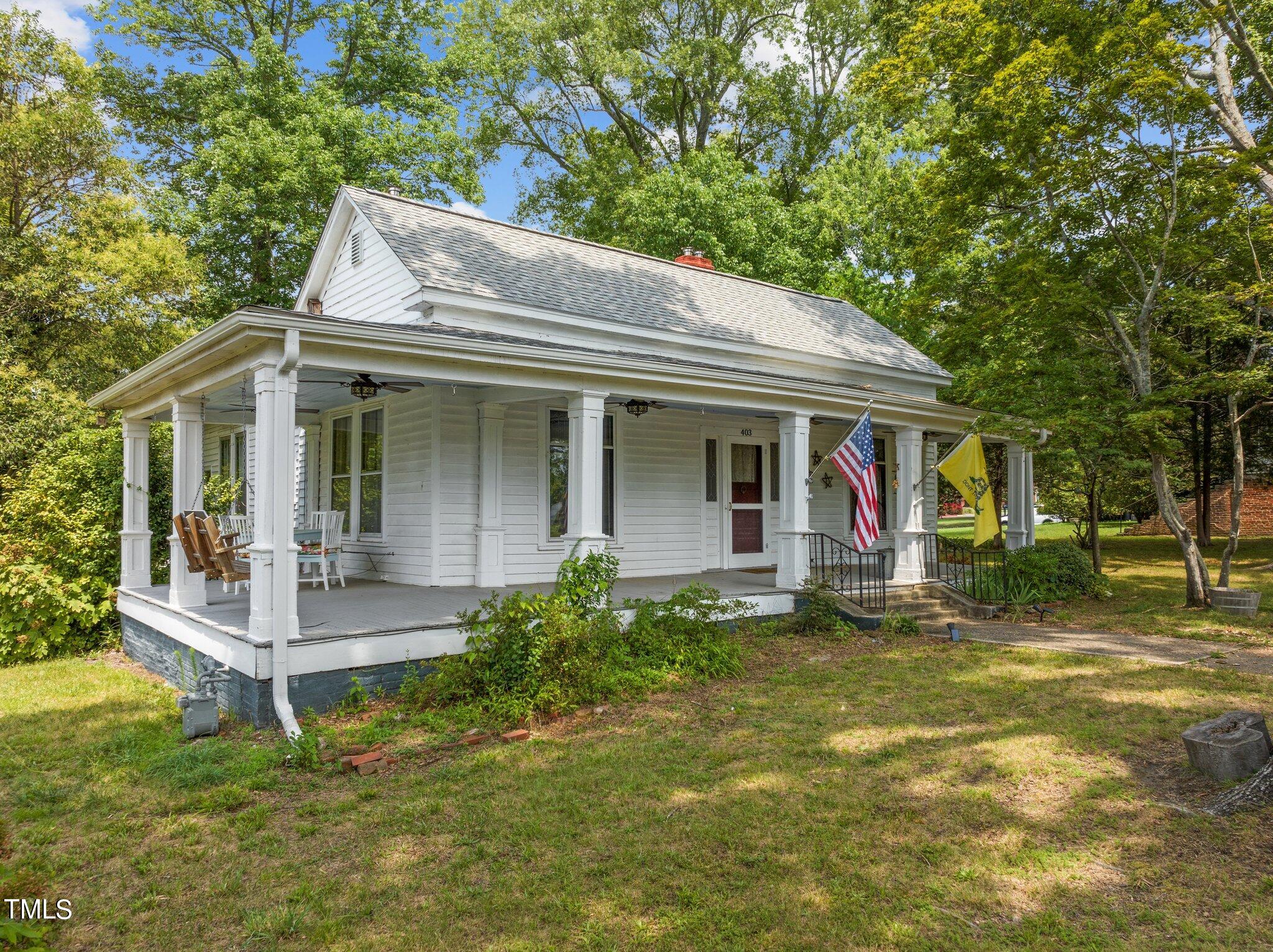 a view of a house with a yard porch and sitting area