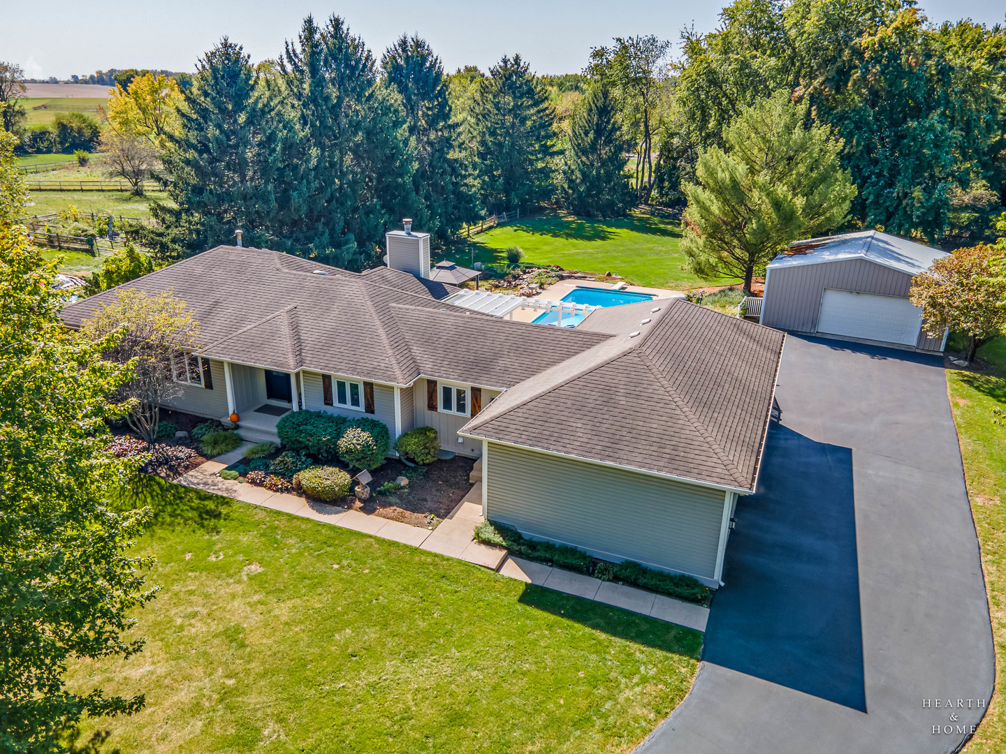 an aerial view of a house with swimming pool and patio