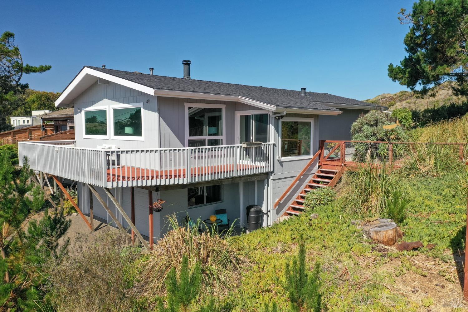 a view of a house with wooden deck