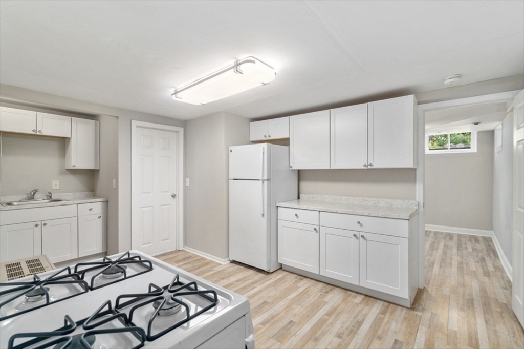 a kitchen with stainless steel appliances granite countertop a stove and a refrigerator