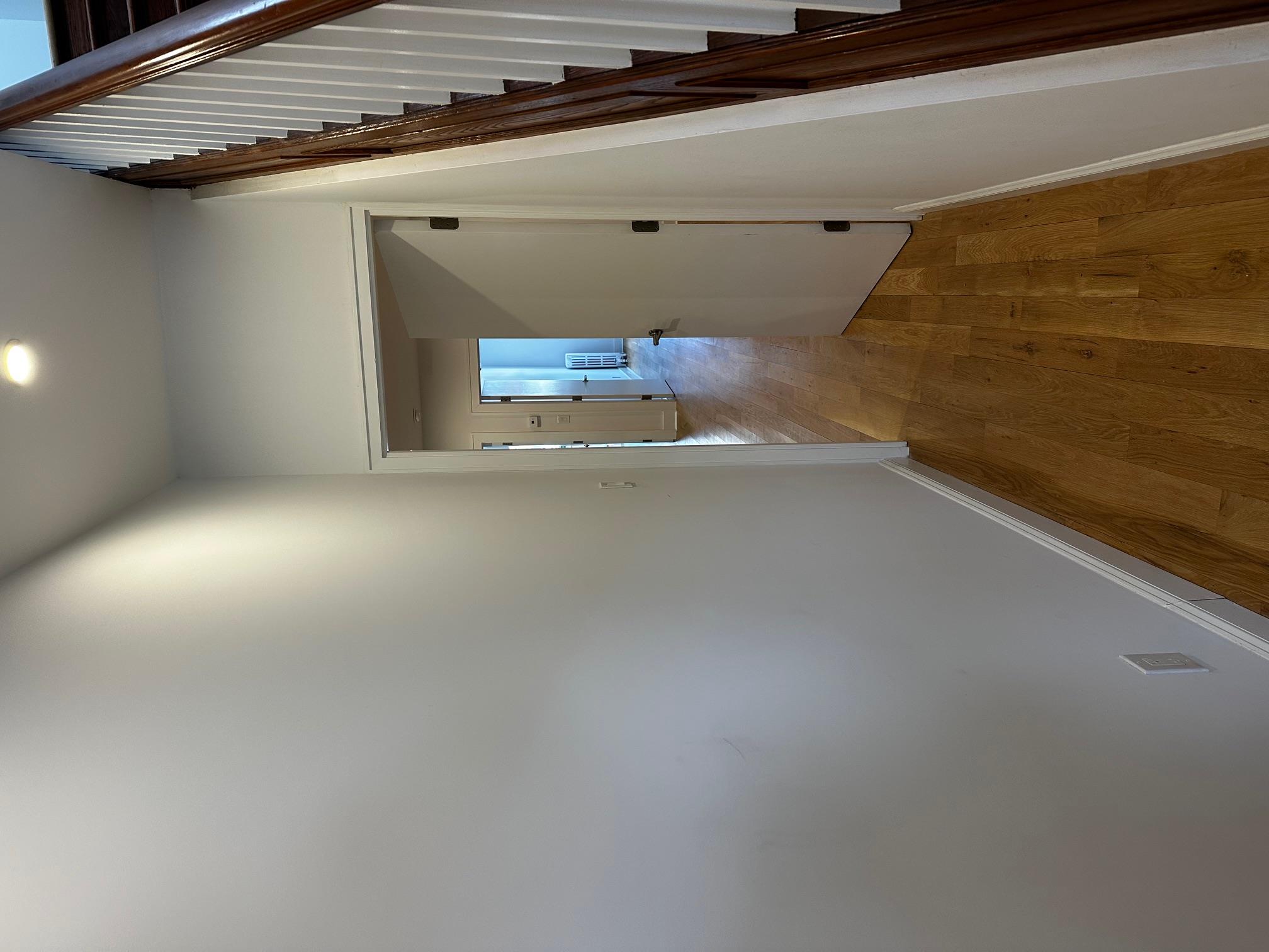 a view of hallway with wooden floor