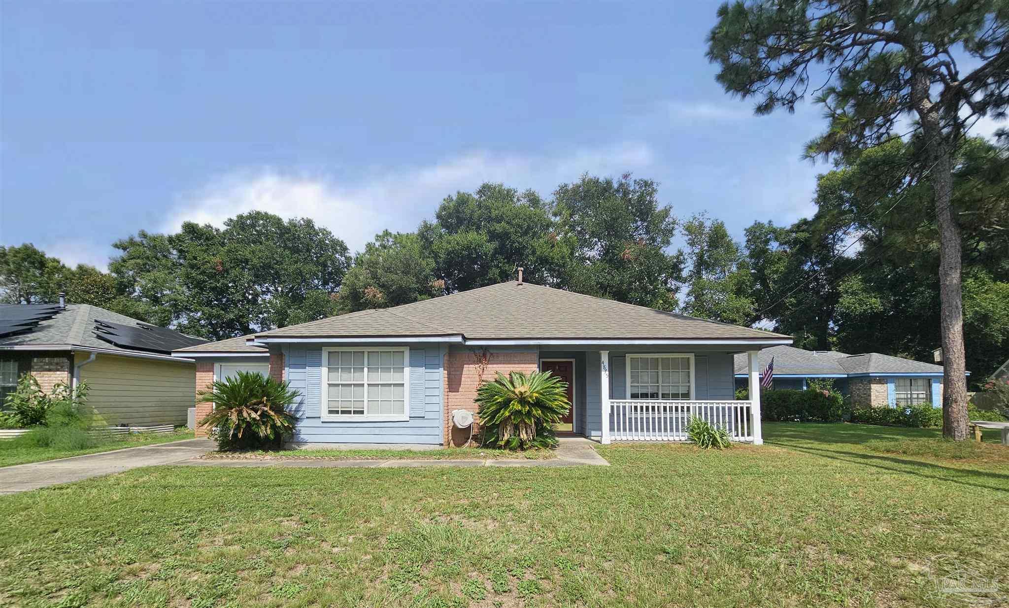 a front view of a house with a garden