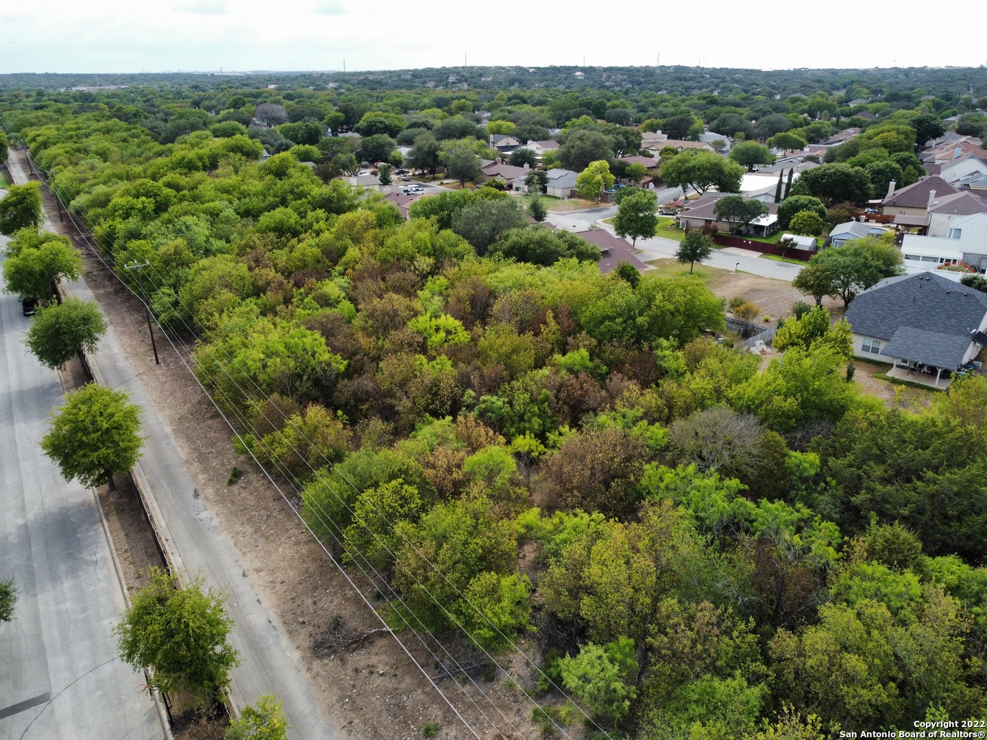 an aerial view of a houses with a yard