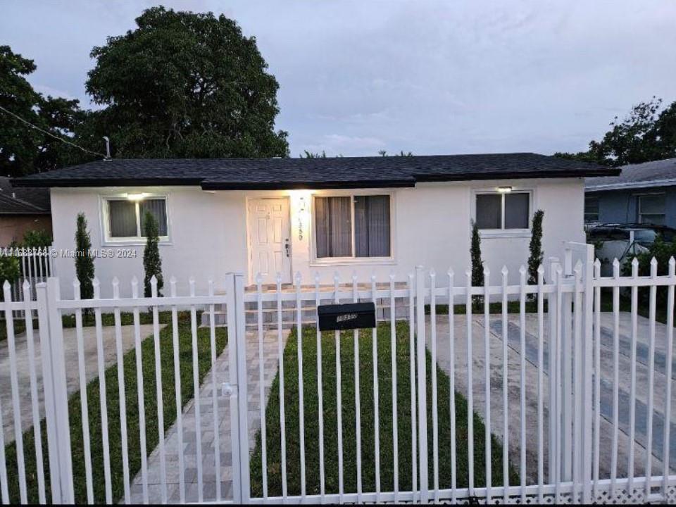 a view of a house with wooden deck and furniture