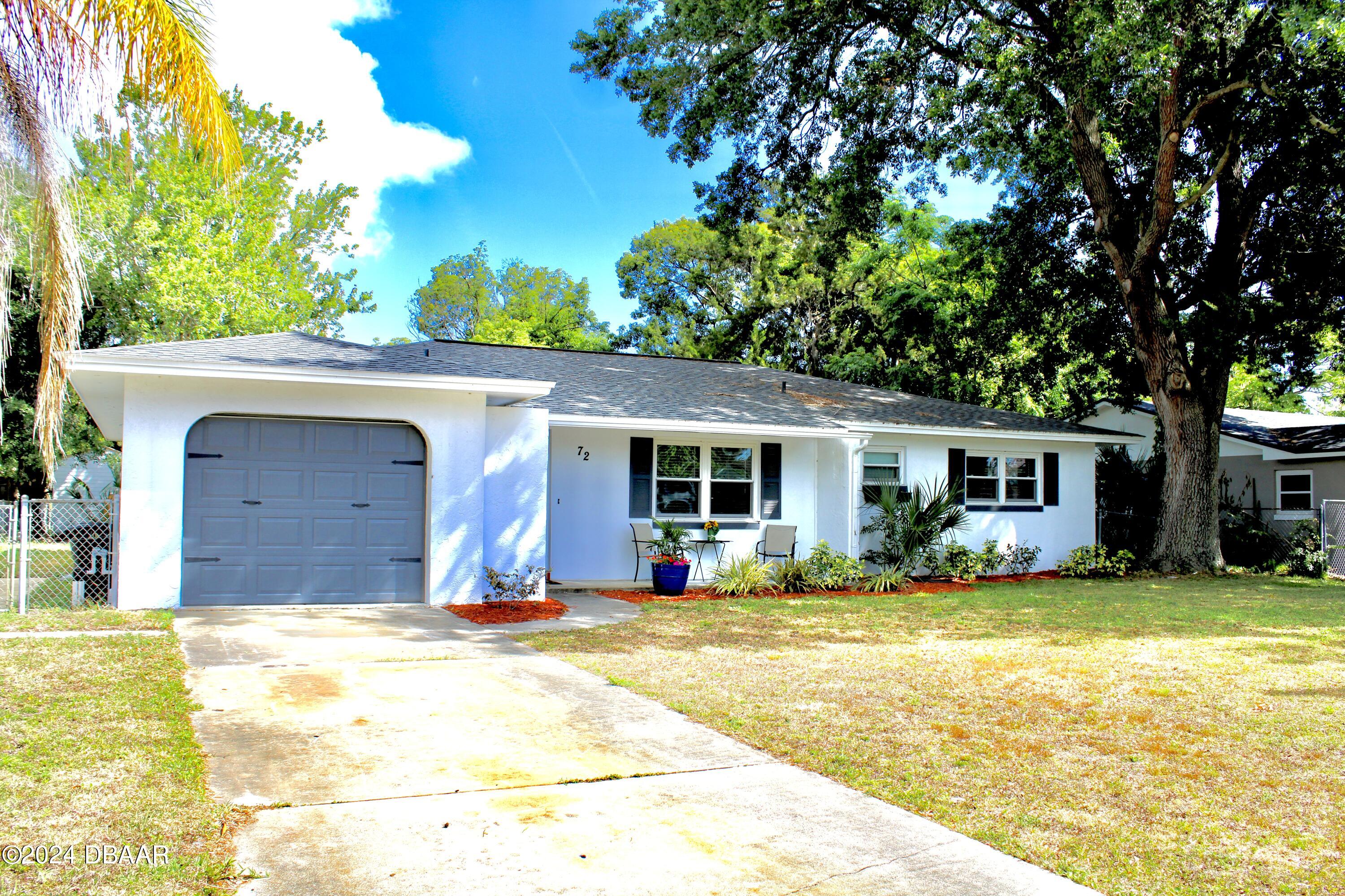 a view of a house with pool and a yard