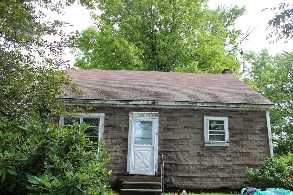 a view of a house with a tree