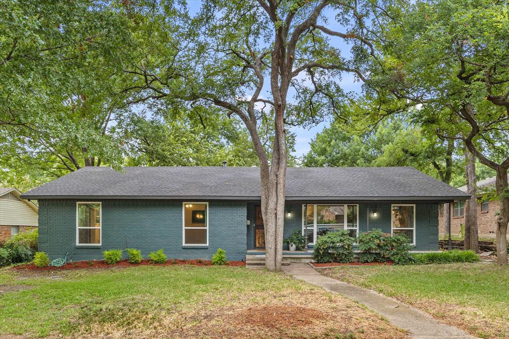 a front view of a house with a yard and porch