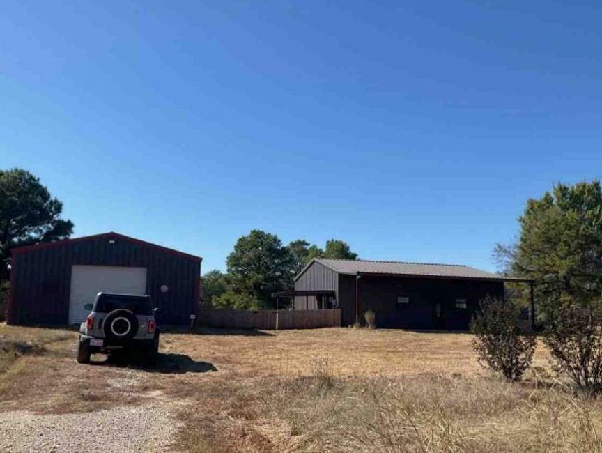 a view of a house with a yard and a garage