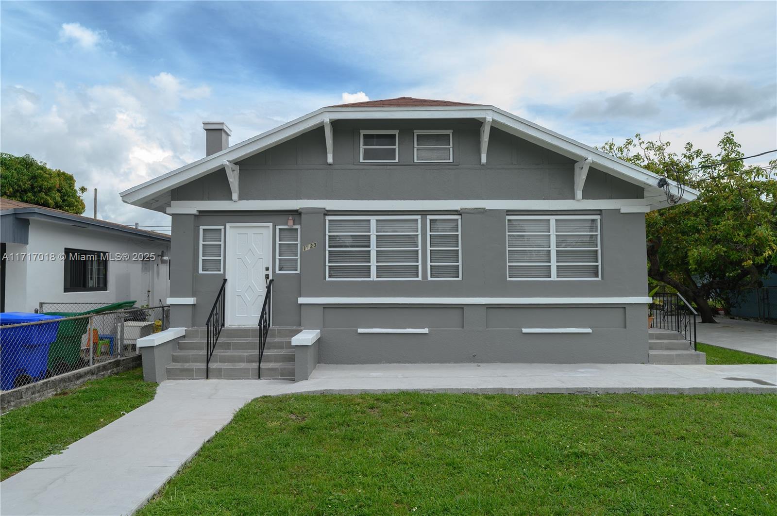 a front view of house with yard and outdoor seating