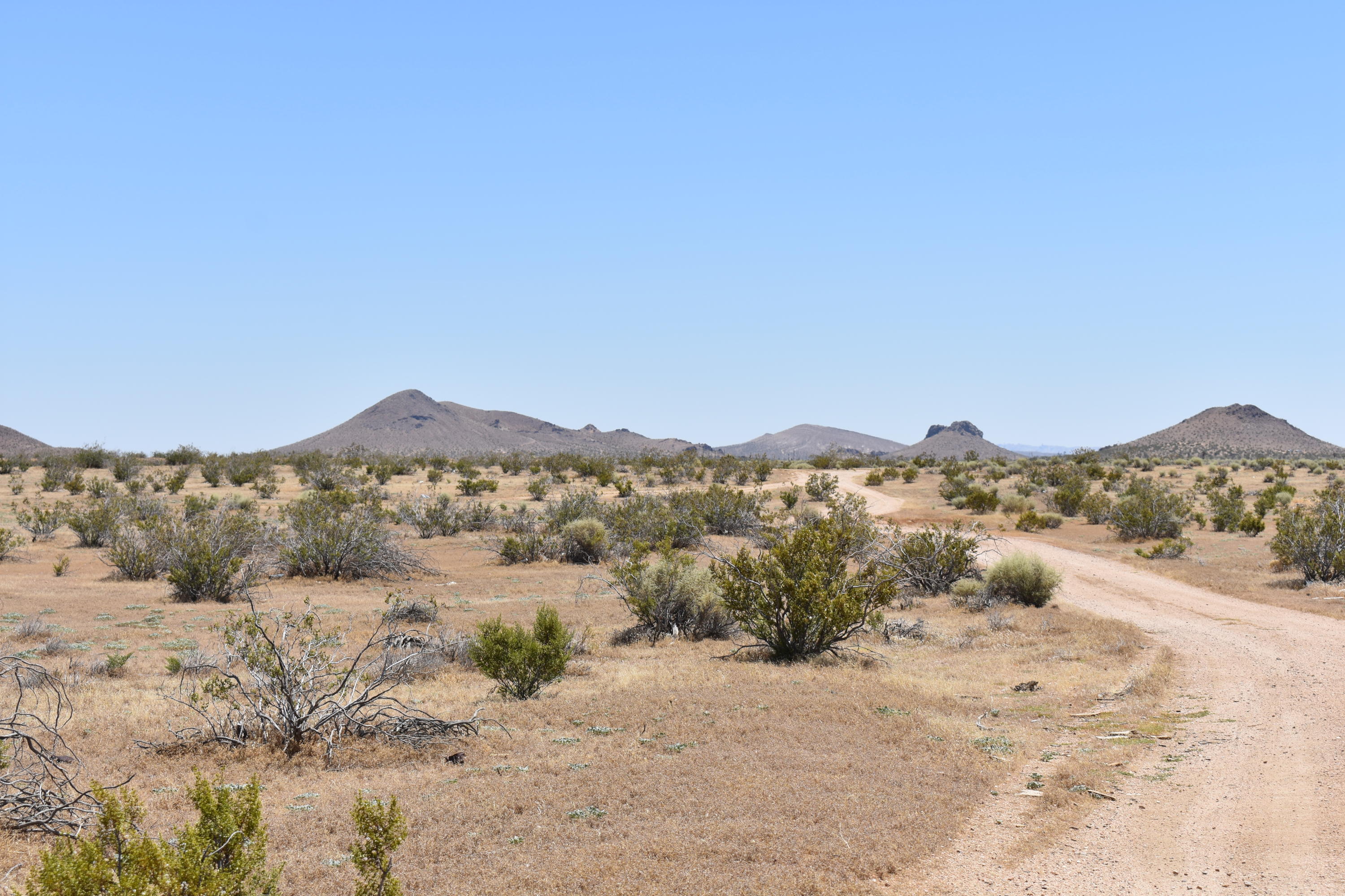 a view of a large mountain with mountains in the background