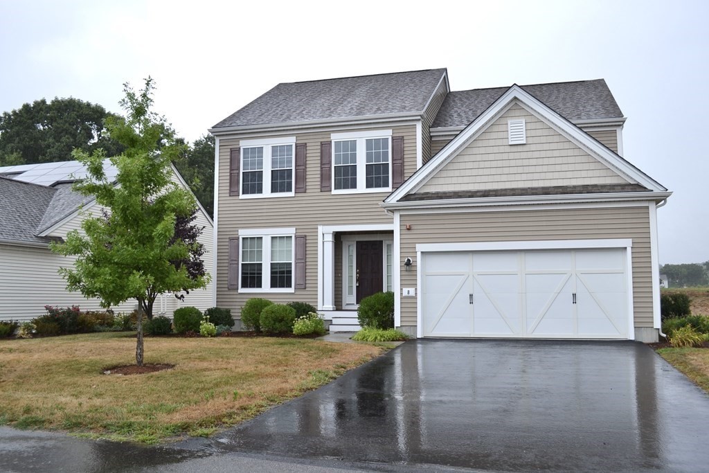 a front view of a house with a yard and garage