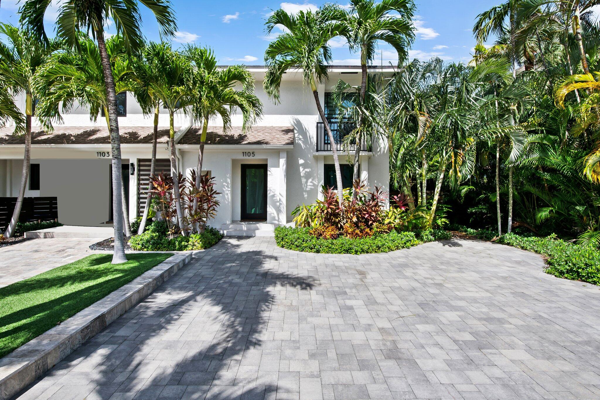 a front view of a house with a garden