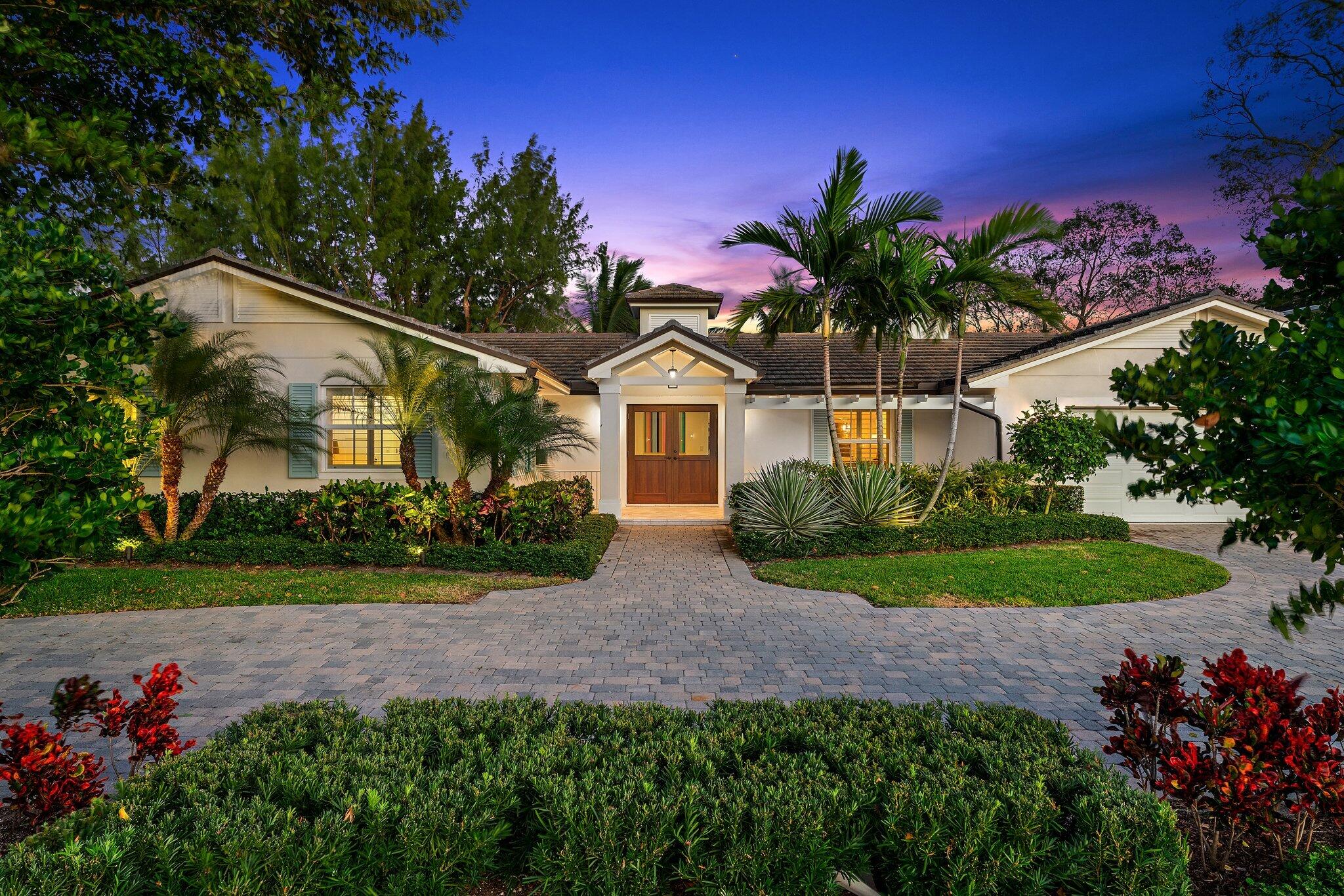 a front view of a house with a garden