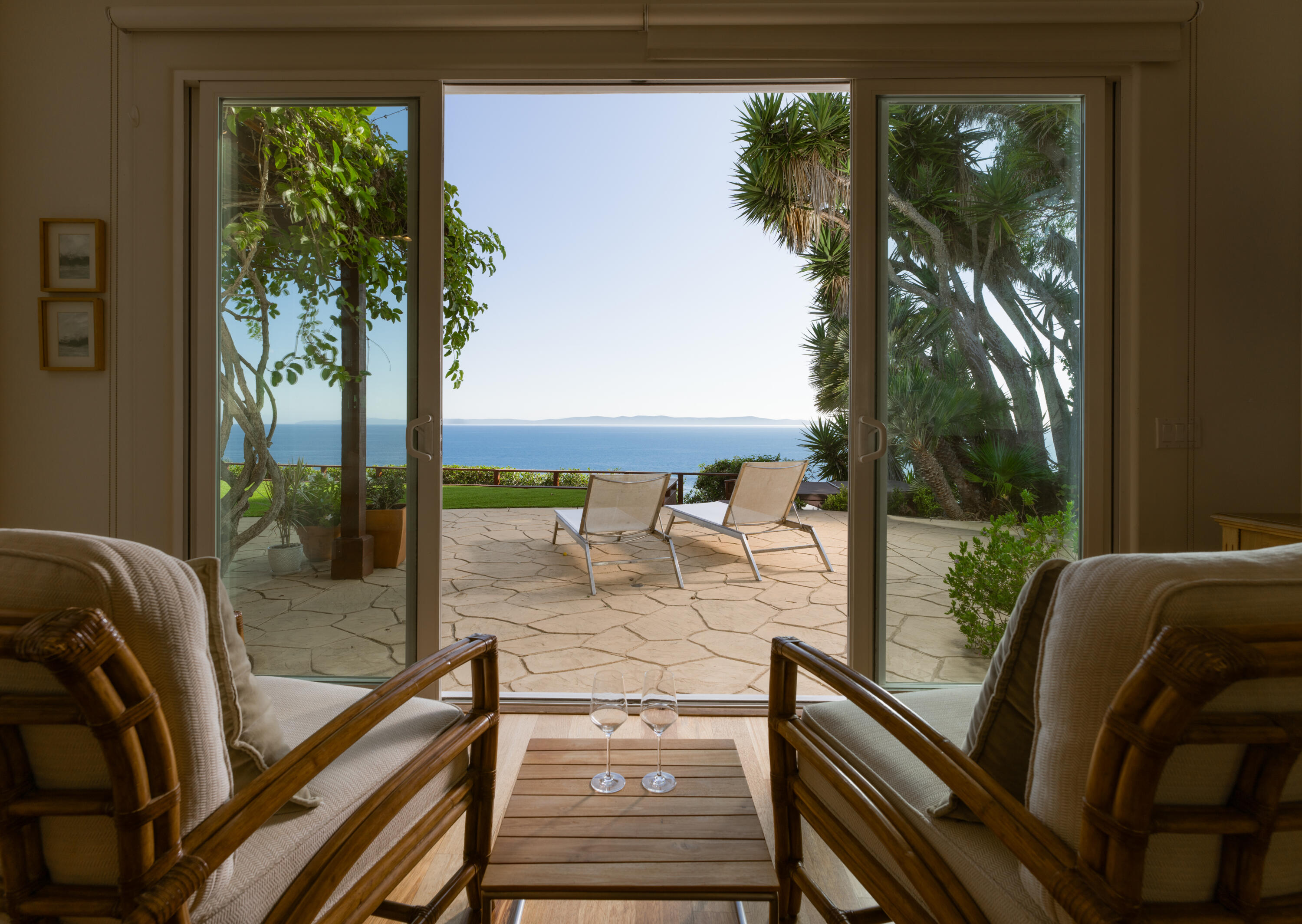 a view of a balcony with floor to ceiling windows with wooden floor