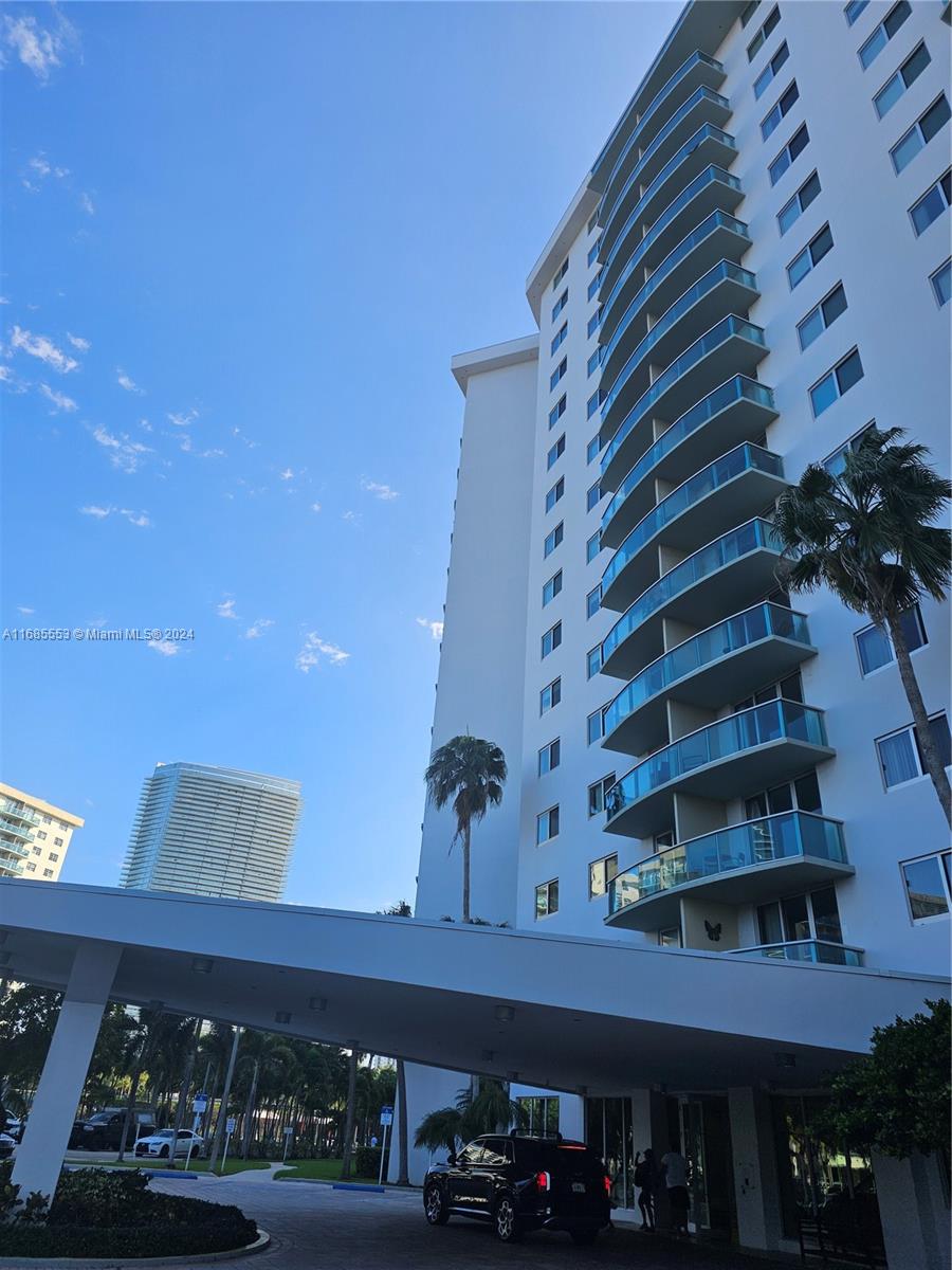 a front view of a building with parking