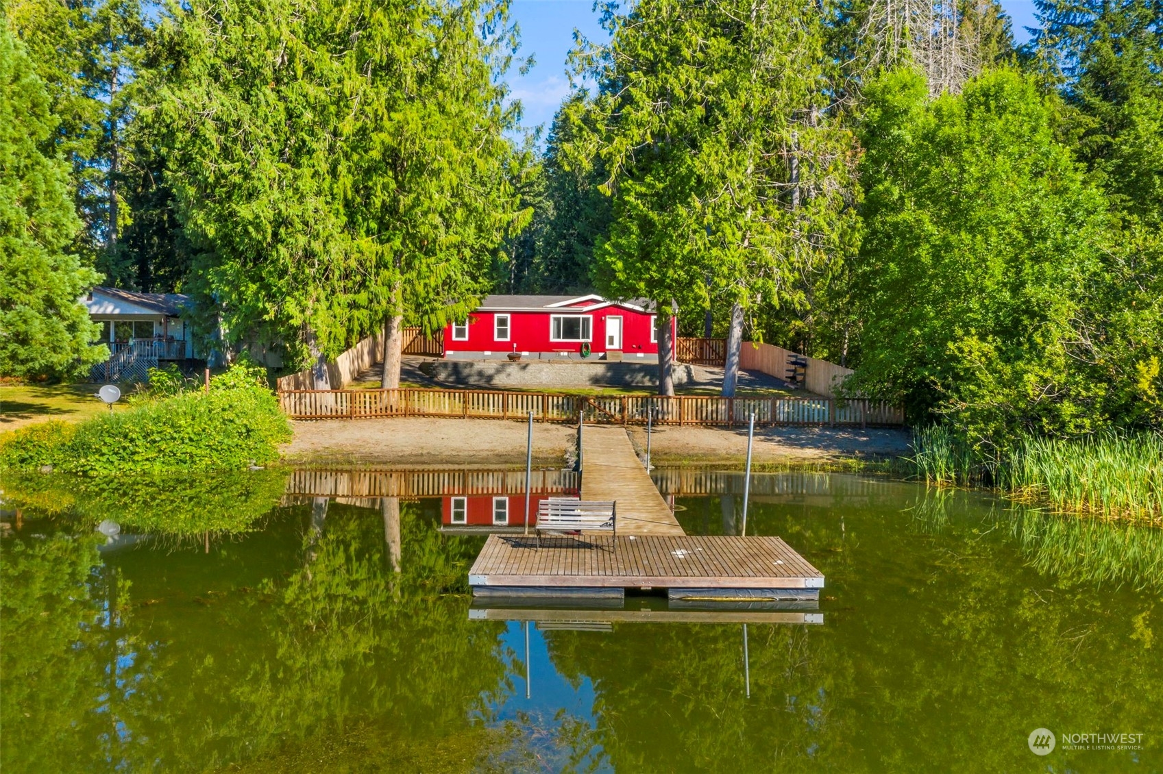 a wooden bench sitting next to a lake