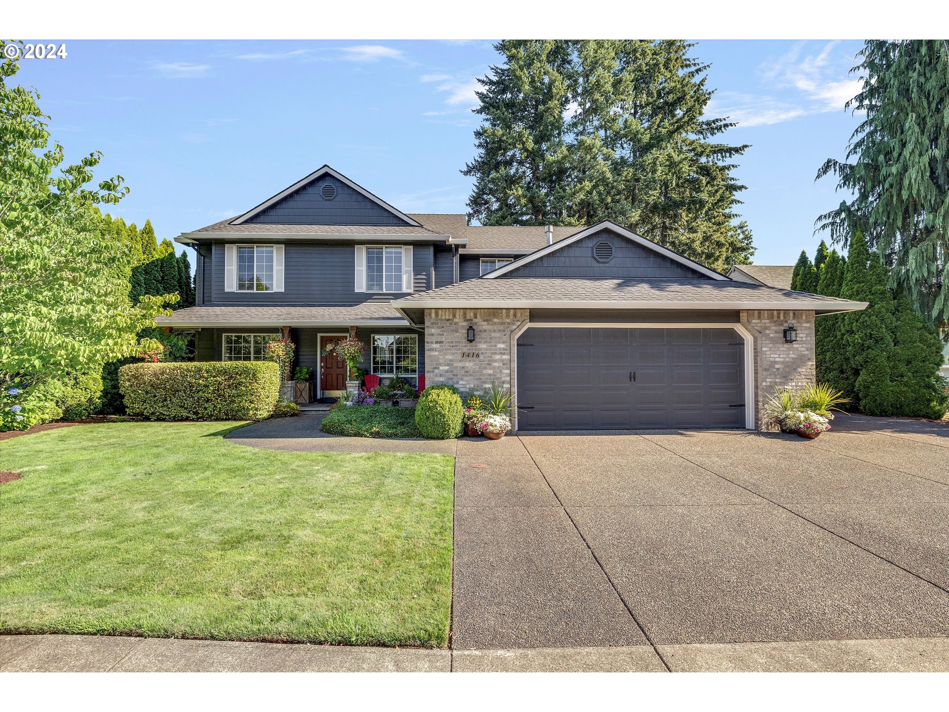 a front view of a house with a yard and garage