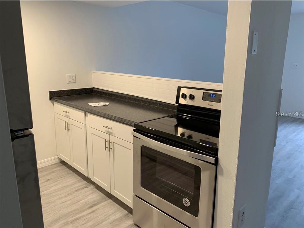 a stove top oven sitting inside of a kitchen