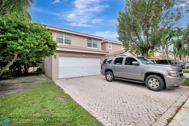 a view of a car parked in front of a house