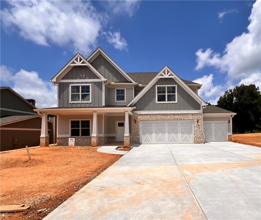 a front view of a house with yard and garage