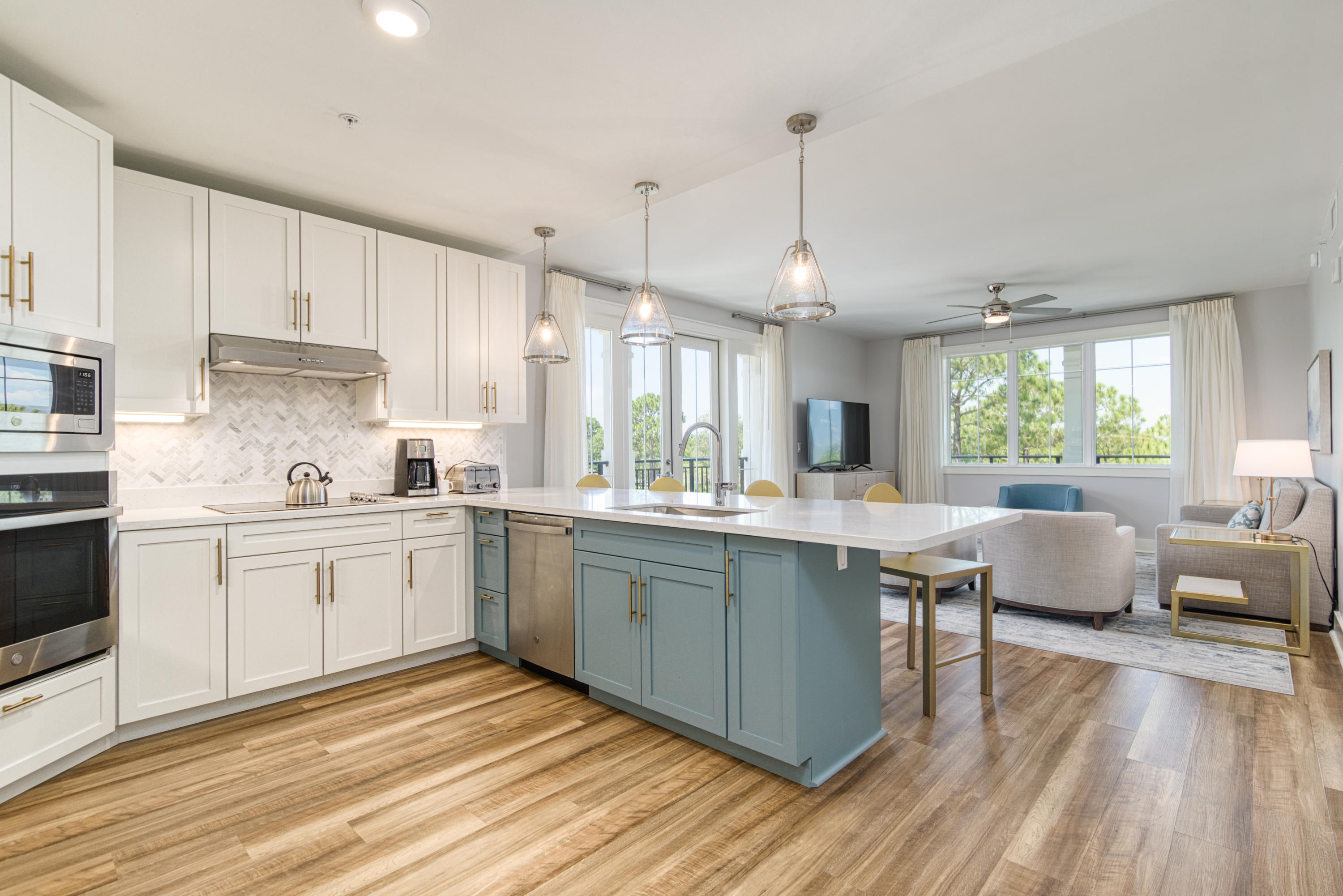 a kitchen with counter top space sink stove and cabinets