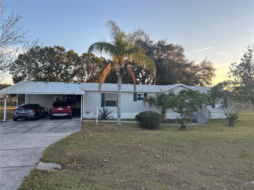 a view of a house with a yard and garage