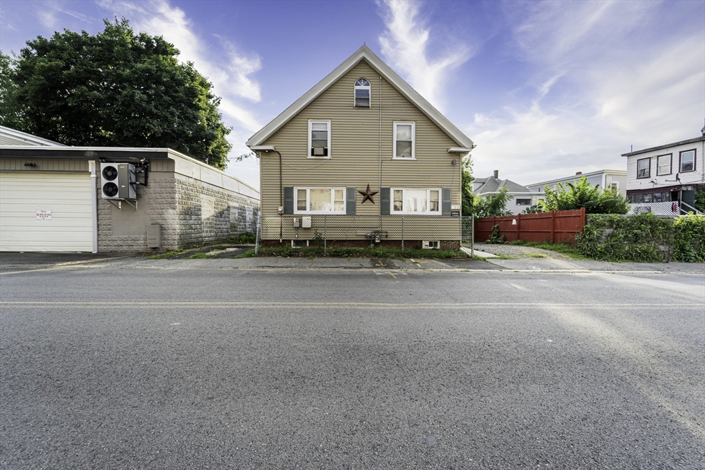 a view of street along with house and trees