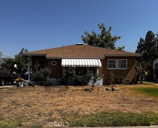 a view of a house with backyard porch and sitting area