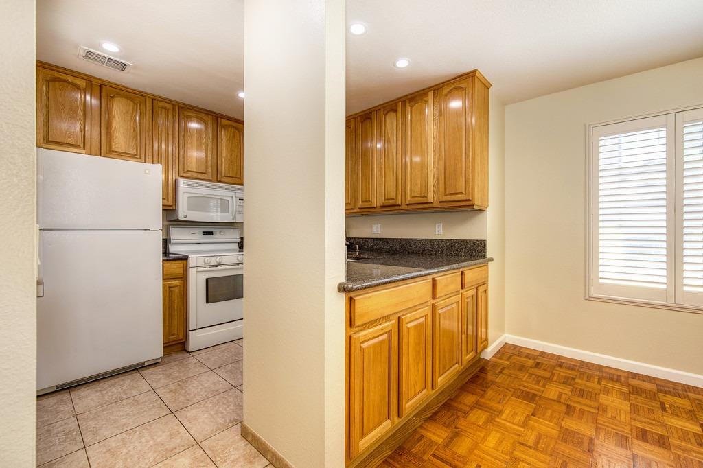 a kitchen with granite countertop cabinets and refrigerator