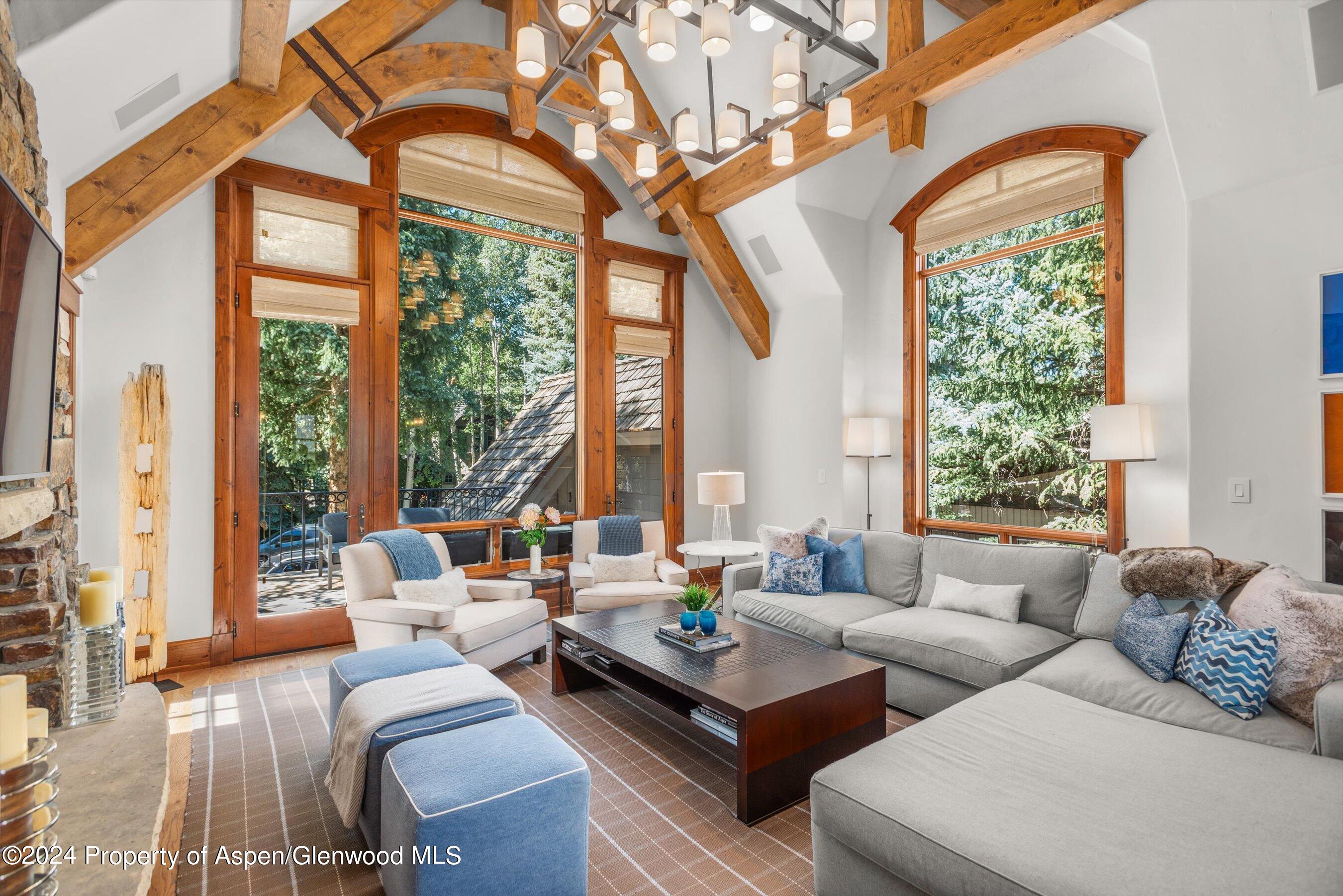 a living room with furniture and large windows