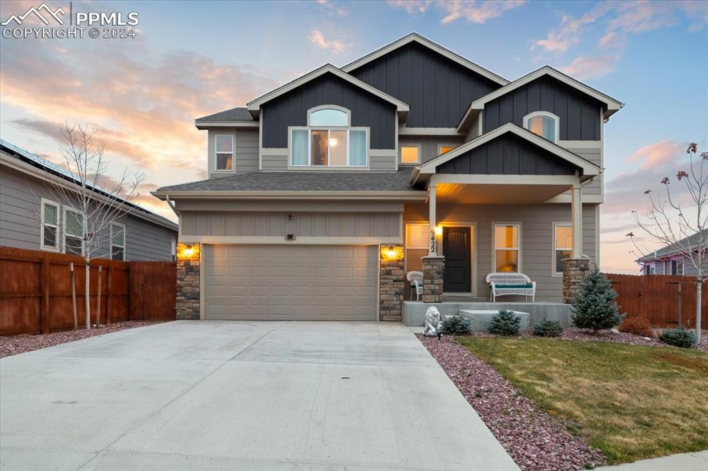 a front view of a house with a yard and garage