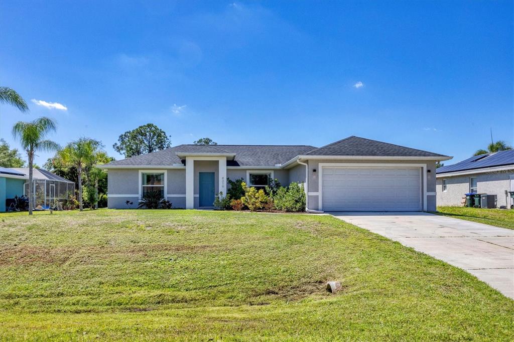 a front view of a house with a yard and garage