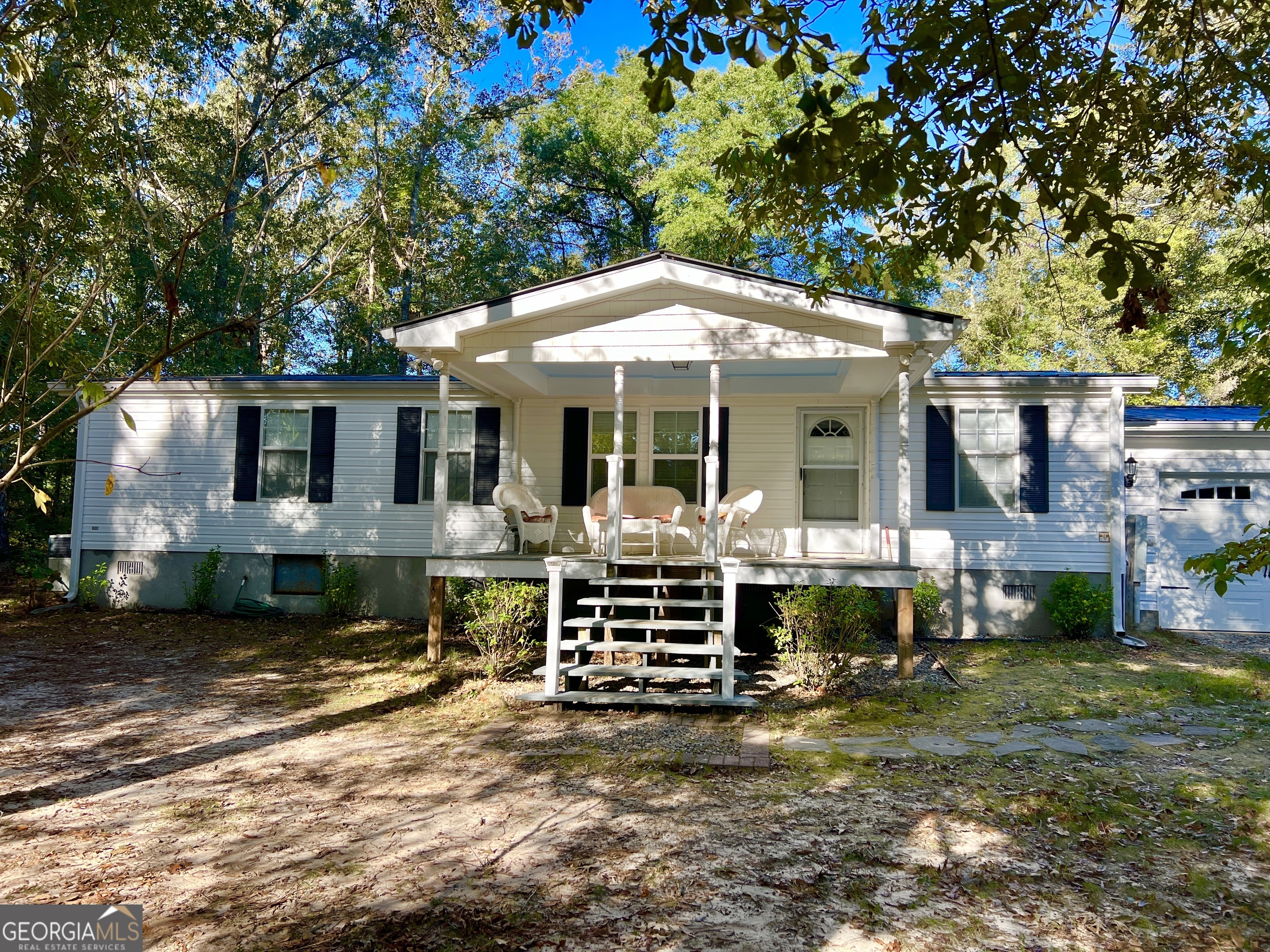 a view of a house with backyard porch and sitting area