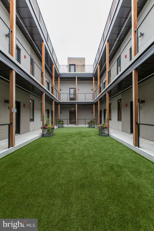 a view of an apartment with a backyard