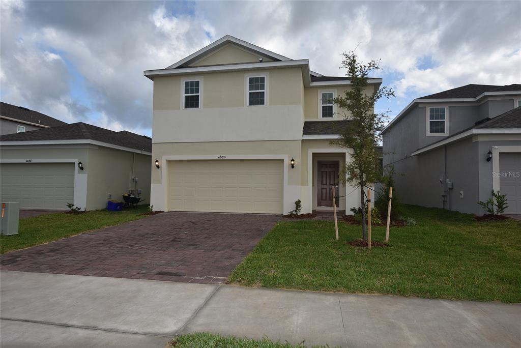 a front view of a house with a yard and garage