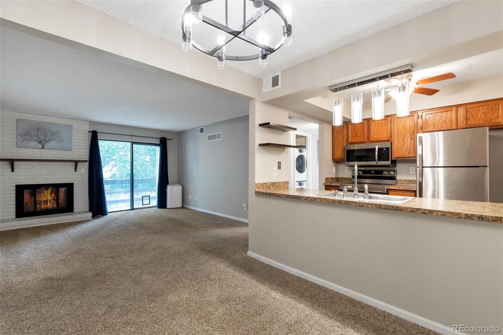 a large kitchen with stainless steel appliances granite countertop a sink and cabinets