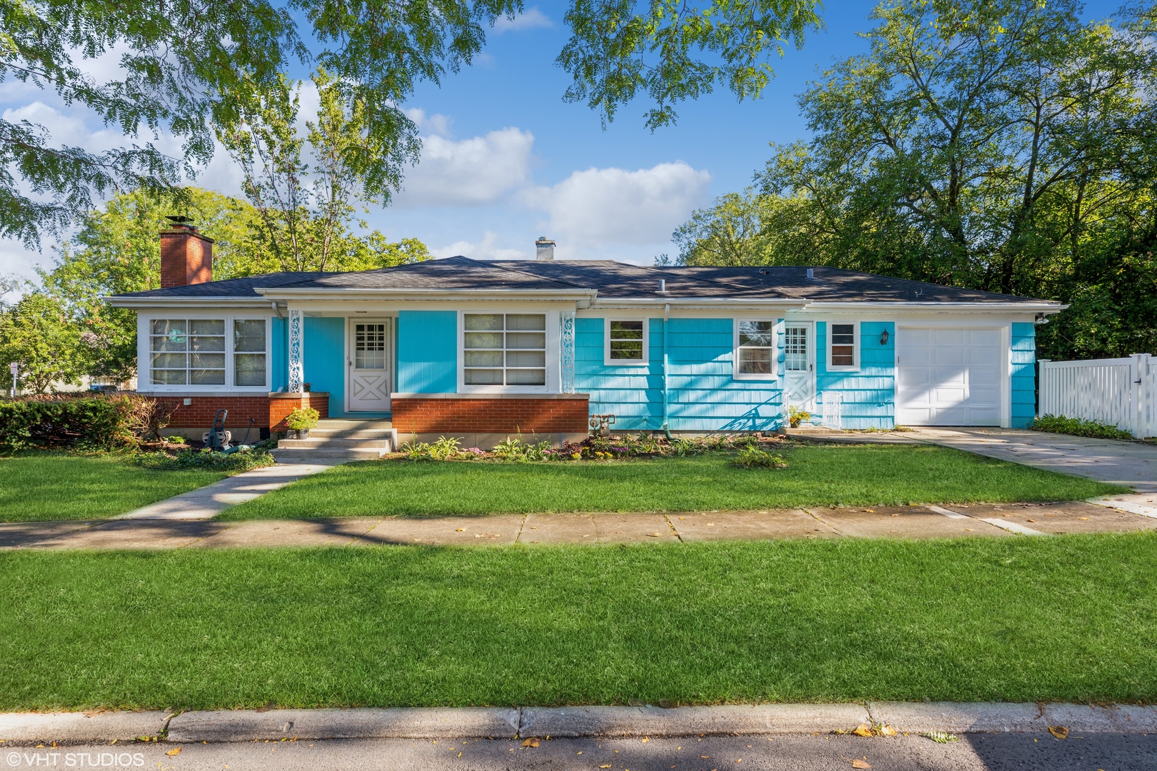 a front view of house with yard and green space