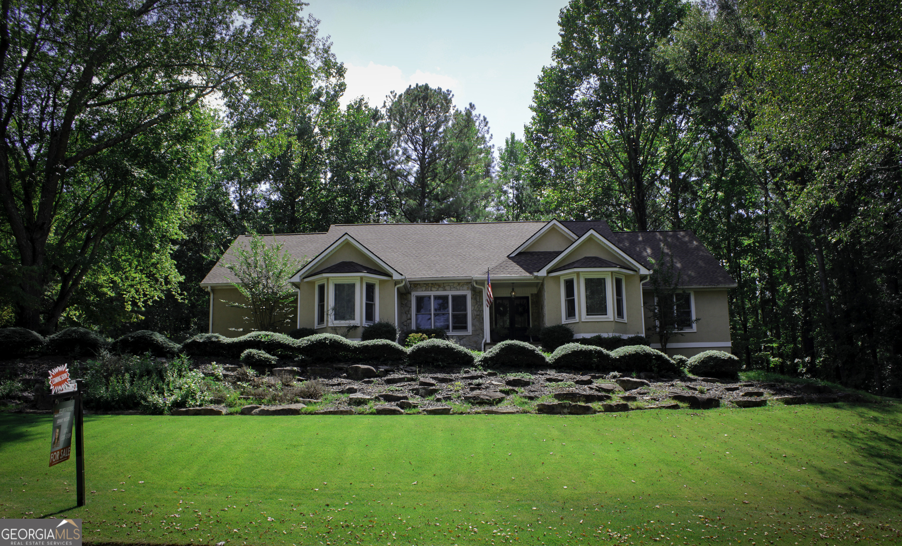 a front view of a house with garden