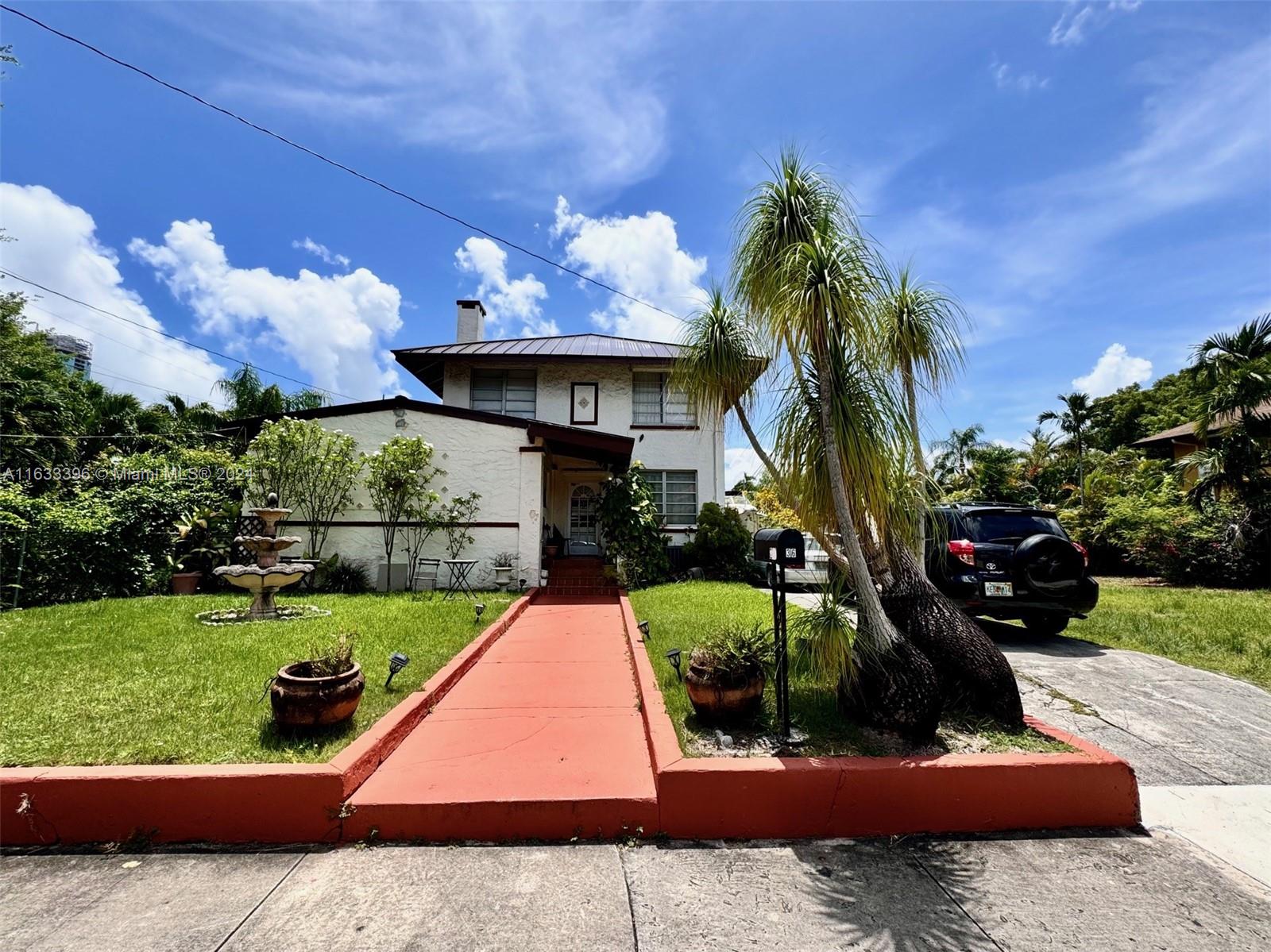 a view of a house with a yard